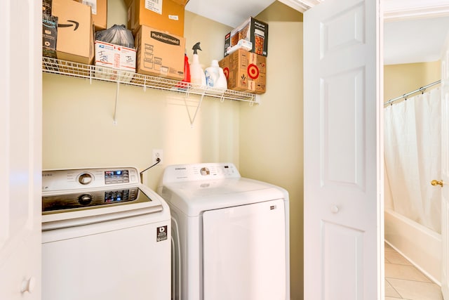 laundry area featuring independent washer and dryer and light tile patterned flooring