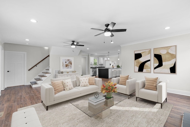 living room with ceiling fan and light hardwood / wood-style flooring