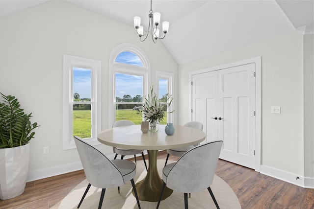 dining area featuring dark hardwood / wood-style flooring, a wealth of natural light, and lofted ceiling