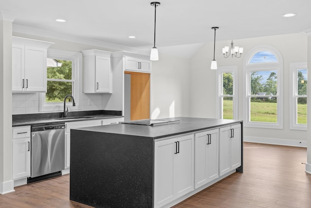 kitchen with white cabinets, dishwasher, light hardwood / wood-style flooring, sink, and tasteful backsplash