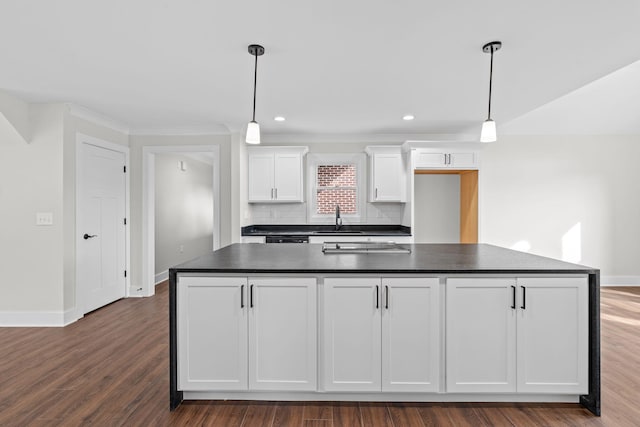 kitchen featuring a center island, dark hardwood / wood-style flooring, white cabinets, and tasteful backsplash