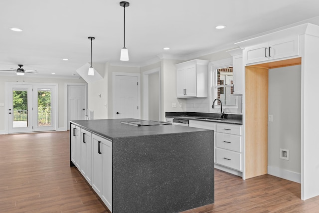 kitchen with pendant lighting, dark hardwood / wood-style flooring, sink, ceiling fan, and white cabinets