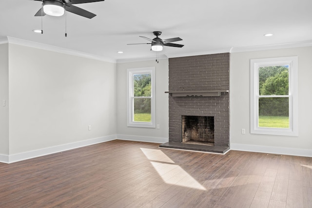 unfurnished living room with a fireplace, plenty of natural light, hardwood / wood-style flooring, and ceiling fan