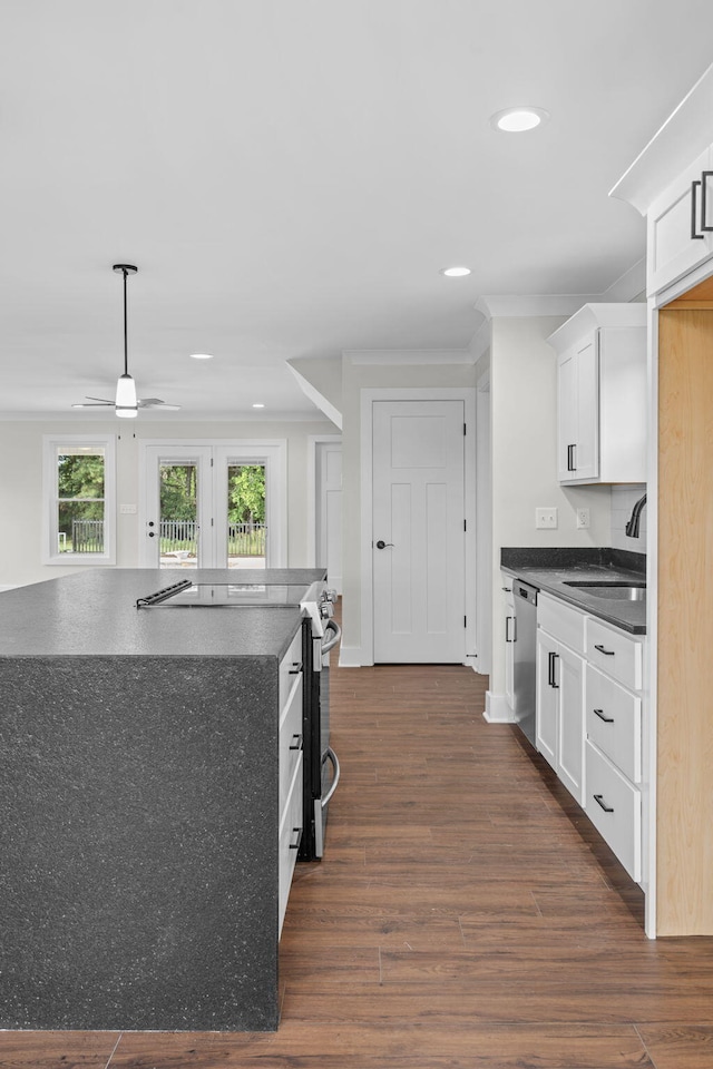 kitchen with dark hardwood / wood-style floors, stainless steel appliances, sink, white cabinetry, and ceiling fan