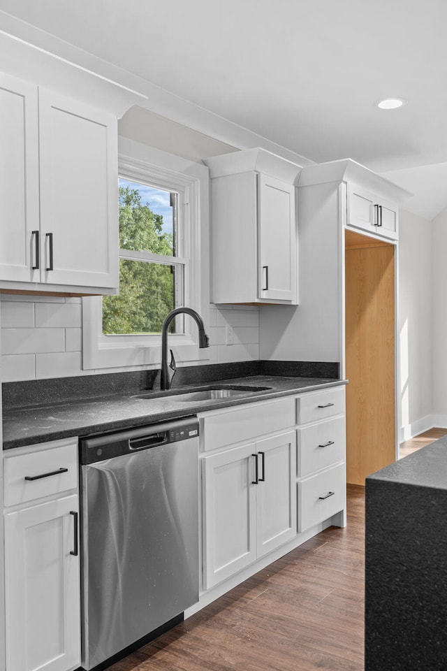 kitchen featuring dishwasher, sink, white cabinets, and dark hardwood / wood-style floors