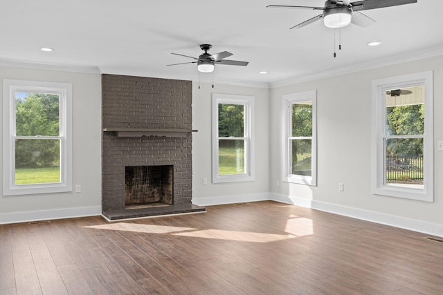 unfurnished living room with dark wood-type flooring, ceiling fan, and a wealth of natural light