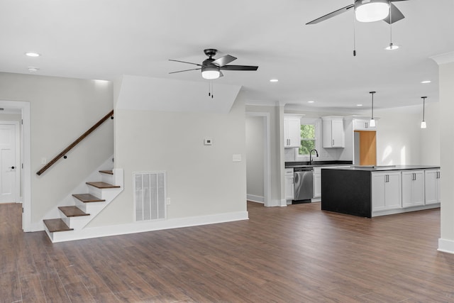 unfurnished living room with dark wood-type flooring, ceiling fan, and sink