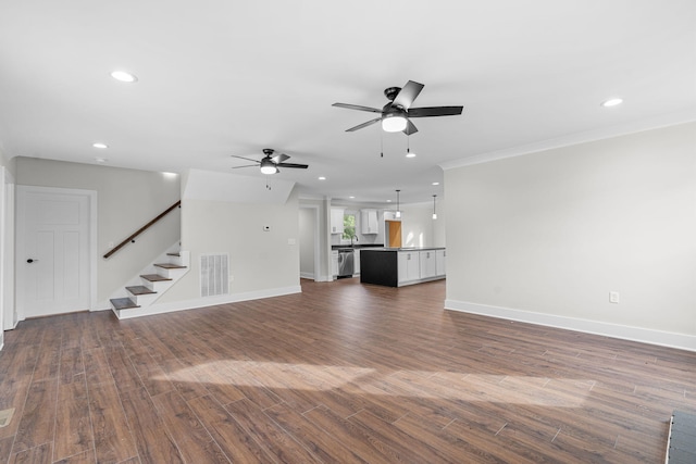 unfurnished living room featuring ceiling fan and hardwood / wood-style flooring