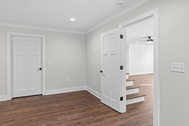 unfurnished room with ornamental molding, dark wood-type flooring, and ceiling fan