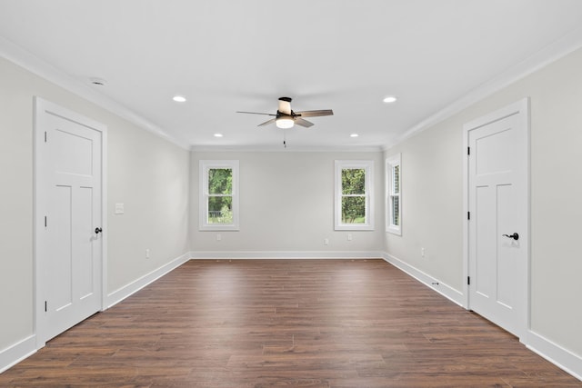 empty room with ornamental molding, dark wood-type flooring, and ceiling fan