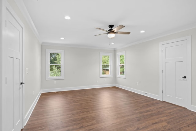 empty room with crown molding, dark wood-type flooring, and ceiling fan