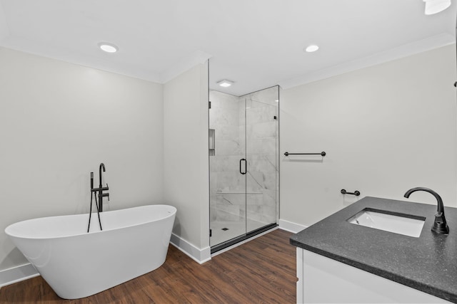 bathroom featuring crown molding, vanity, hardwood / wood-style flooring, and separate shower and tub