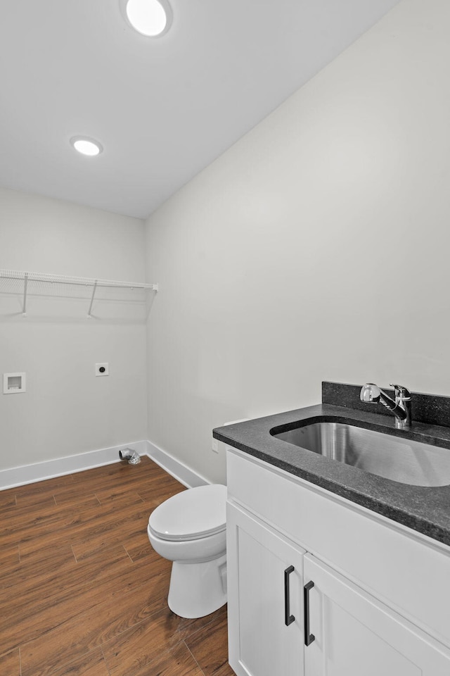 bathroom with vanity, toilet, and hardwood / wood-style flooring