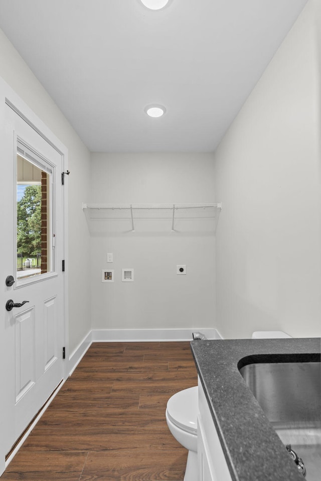 clothes washing area featuring washer hookup, hookup for an electric dryer, dark hardwood / wood-style floors, and sink