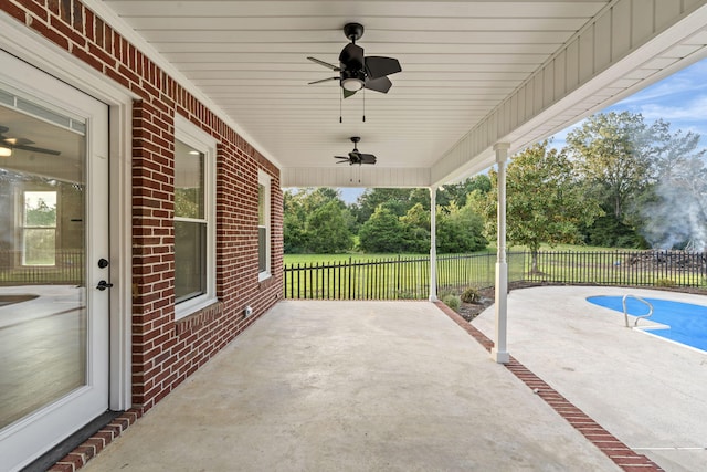 view of patio / terrace featuring a fenced in pool and ceiling fan