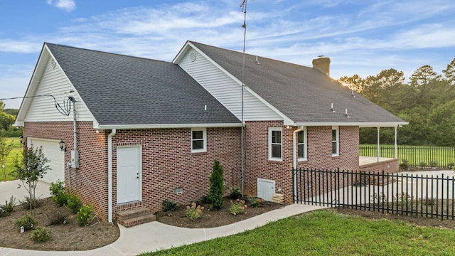 back of property with a garage