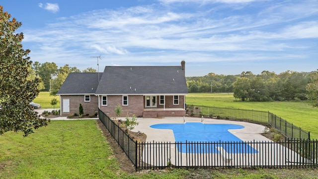 view of swimming pool with a patio area and a yard