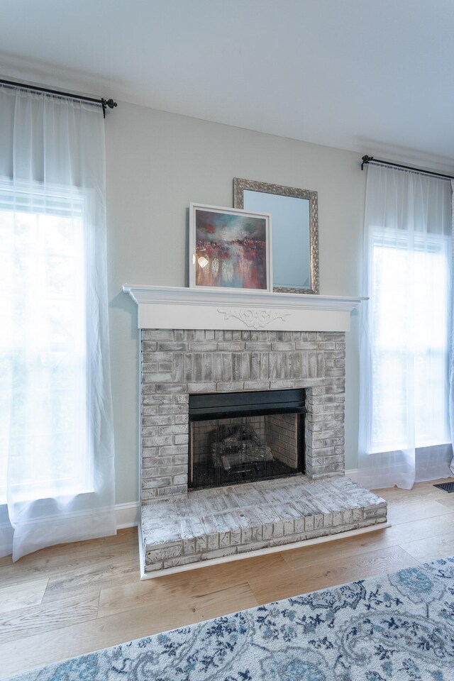 details with hardwood / wood-style floors and a fireplace