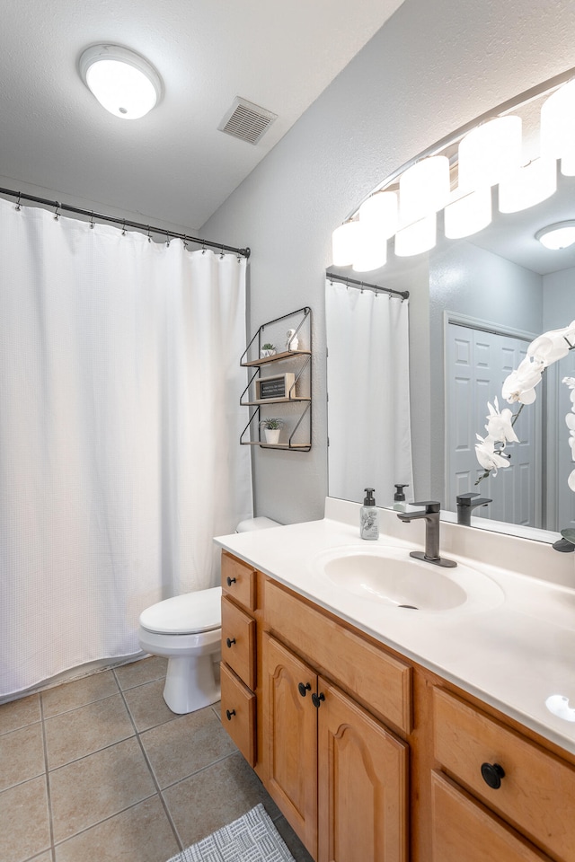 bathroom with tile patterned floors, toilet, and vanity