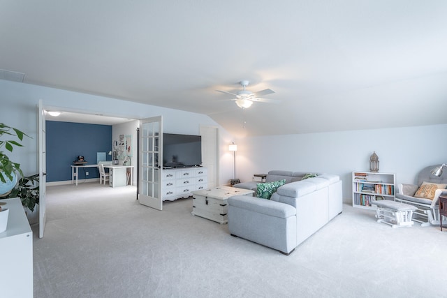 living room featuring vaulted ceiling, carpet floors, and ceiling fan