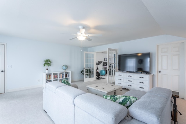 living room featuring french doors, ceiling fan, light carpet, and vaulted ceiling