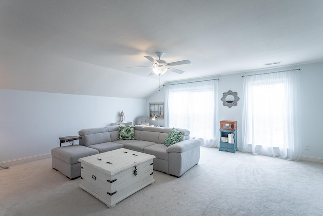 living room featuring light colored carpet, ceiling fan, and vaulted ceiling