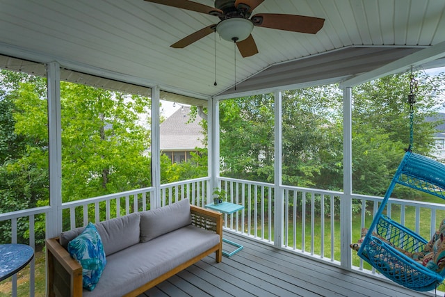 sunroom featuring ceiling fan and vaulted ceiling