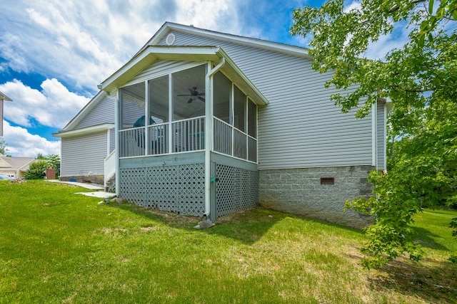 back of house featuring a lawn, ceiling fan, and a sunroom