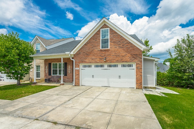 view of front of house featuring a front lawn and a garage