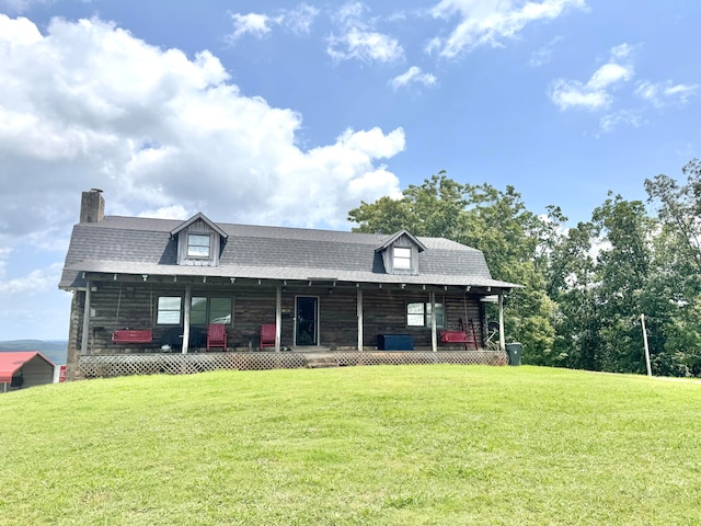 log home featuring a front lawn and covered porch