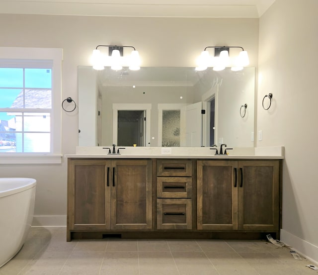 bathroom with tile patterned flooring, vanity, a tub, and a notable chandelier