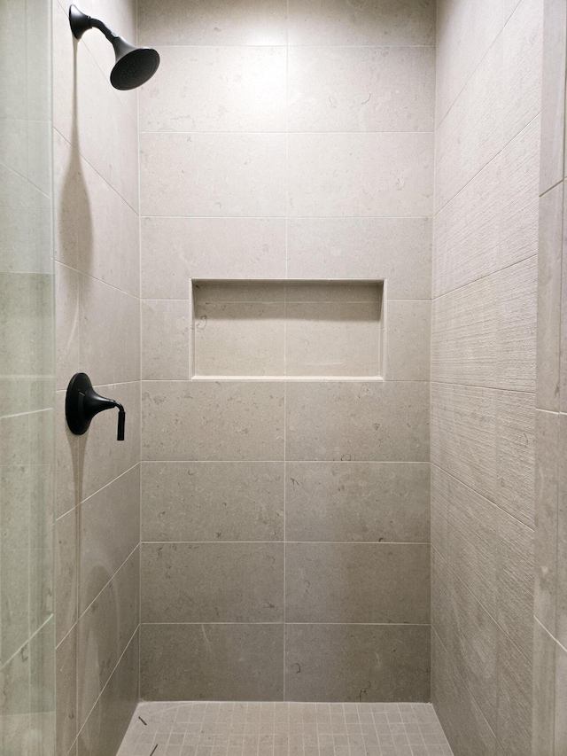 bathroom with a tile shower