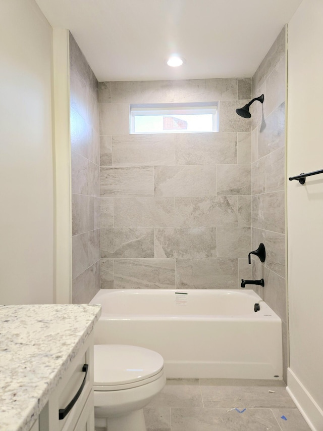 full bathroom featuring vanity, toilet, and tiled shower / bath