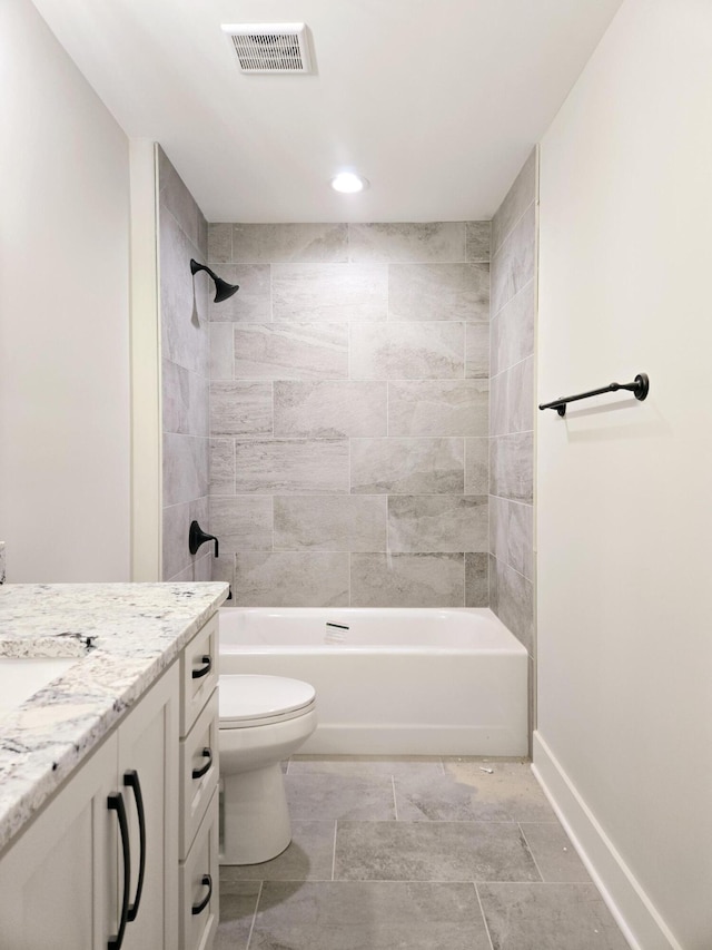 full bathroom with vanity, toilet, and tiled shower / bath combo