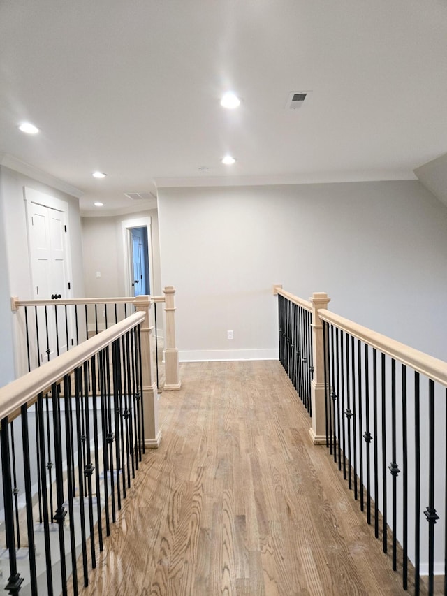 hallway with light wood-type flooring and lofted ceiling