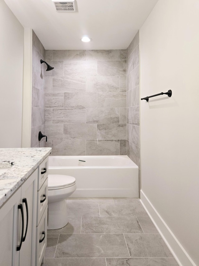 full bathroom with vanity, toilet, and tiled shower / bath