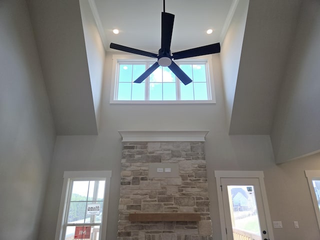 interior details with a ceiling fan and ornamental molding