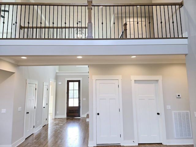 foyer entrance featuring wood finished floors, visible vents, recessed lighting, and baseboards