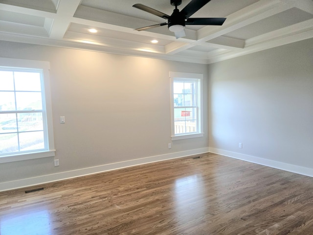 spare room featuring coffered ceiling, a ceiling fan, visible vents, and dark wood finished floors