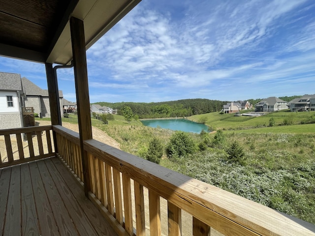 wooden deck featuring a residential view and a water view