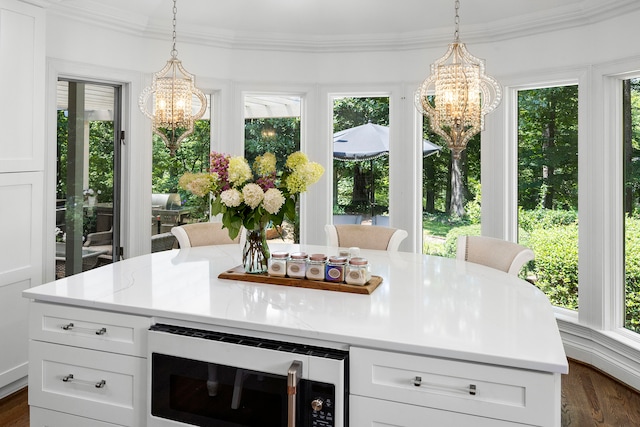 interior space with a wealth of natural light and an inviting chandelier