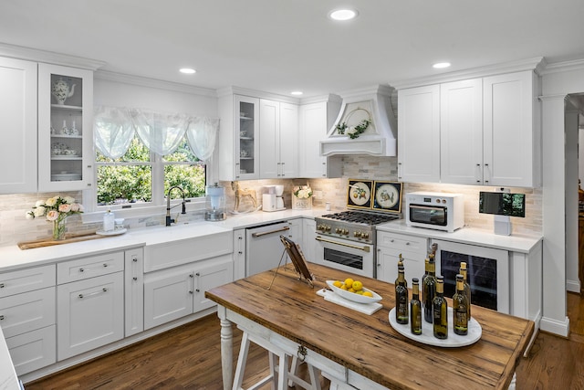 kitchen with custom exhaust hood, white appliances, dark hardwood / wood-style flooring, beverage cooler, and white cabinets