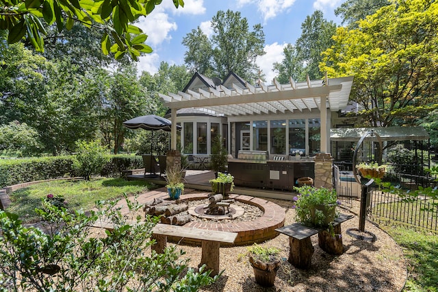 view of yard with a pergola, a fire pit, and a wooden deck