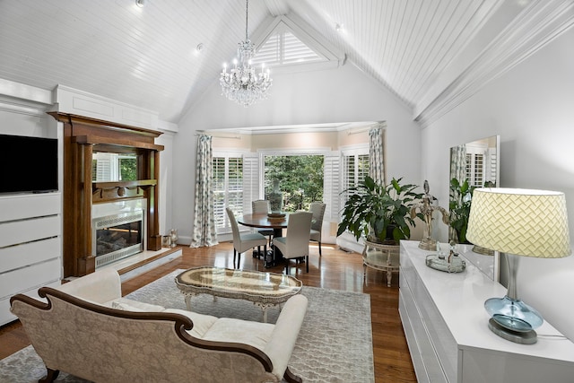 living room featuring a fireplace, dark wood-type flooring, high vaulted ceiling, and a chandelier