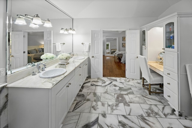 bathroom featuring lofted ceiling and vanity