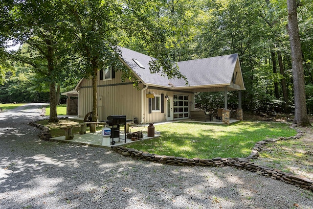 view of front of home featuring french doors, a front yard, and a patio area