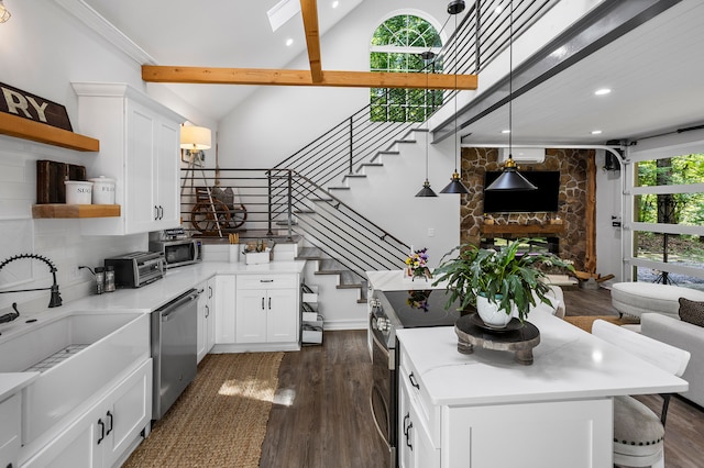 kitchen with dark hardwood / wood-style flooring, plenty of natural light, a kitchen island, and stainless steel appliances