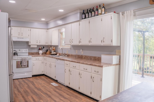 kitchen featuring white appliances, a sink, white cabinets, and under cabinet range hood