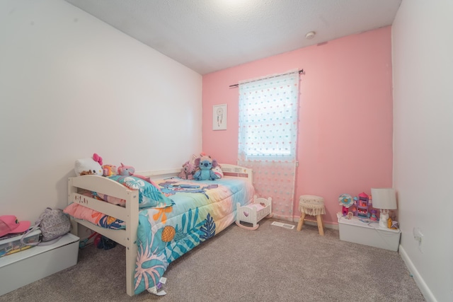 carpeted bedroom with visible vents and baseboards