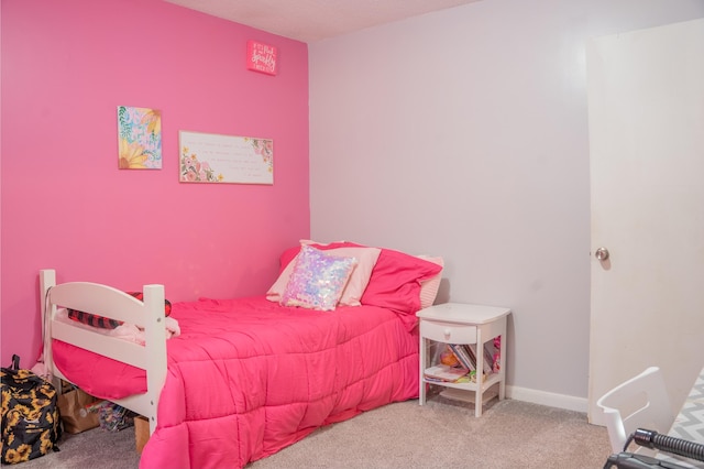 carpeted bedroom featuring baseboards